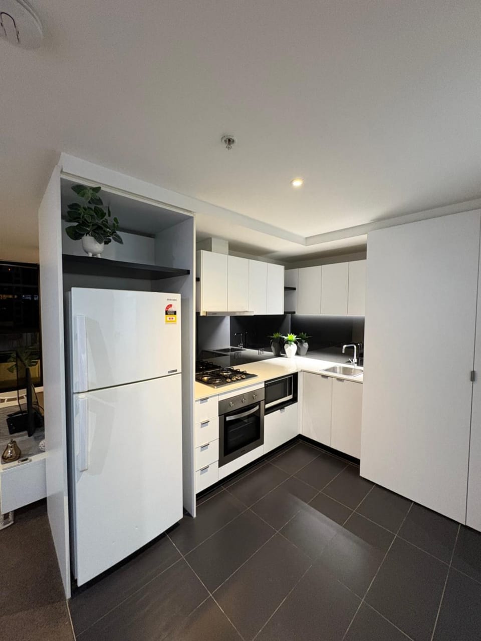 Kitchen or kitchenette, dishwasher, oven, stove