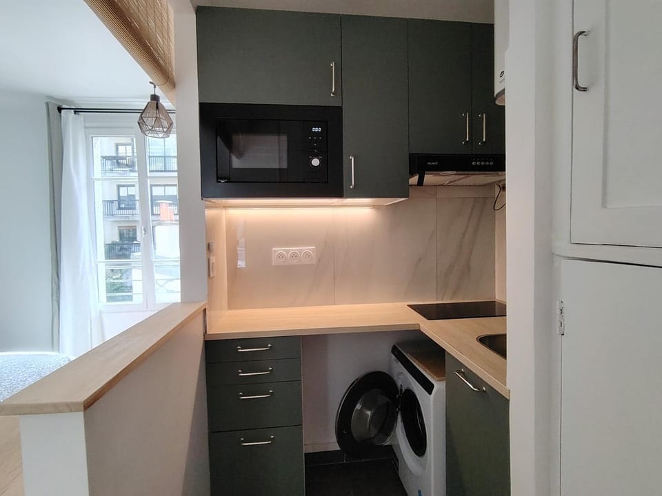 Kitchen or kitchenette, microwave, stove, washing machine