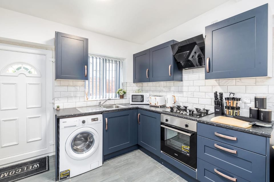 Kitchen or kitchenette, dishwasher, oven, stove, toaster, washing machine, dryer