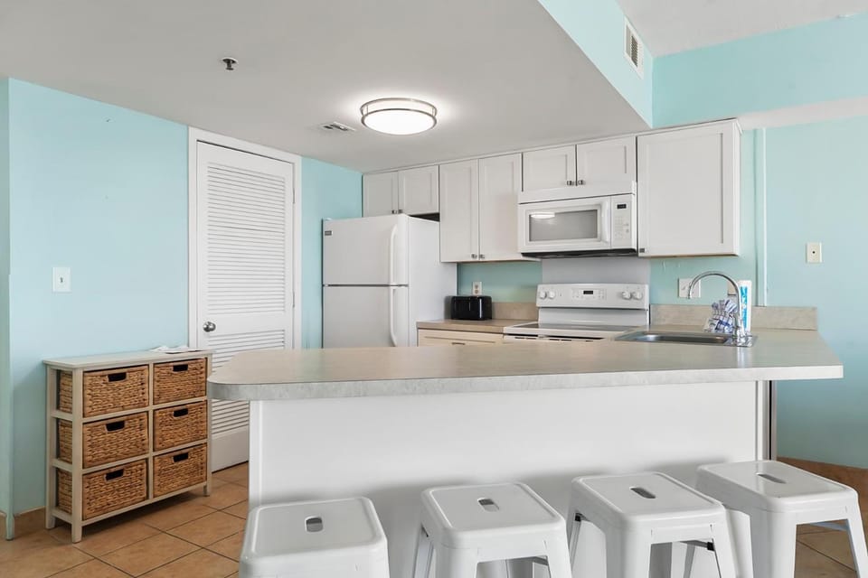 Kitchen or kitchenette, dishwasher, oven, stove