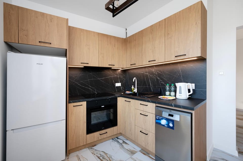 Kitchen or kitchenette, dishwasher, oven, stove
