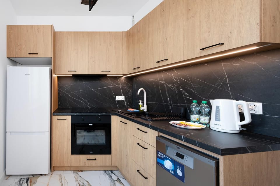 Kitchen or kitchenette, dishwasher, oven, stove
