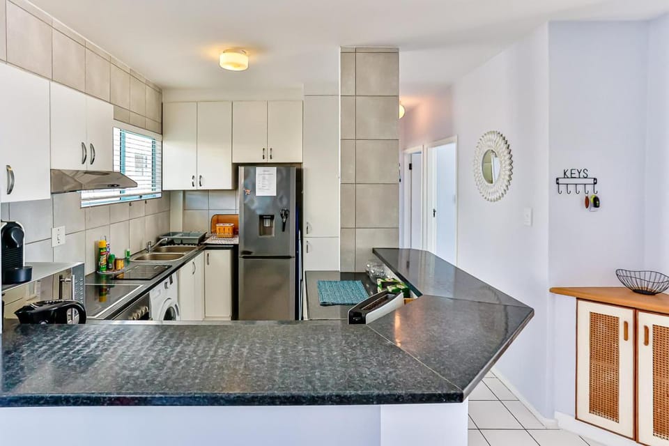 Kitchen or kitchenette, oven, stove, toaster, washing machine