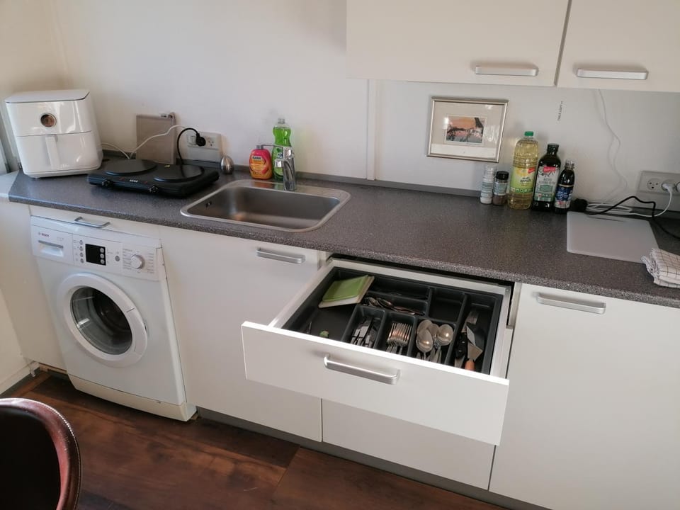 Kitchen or kitchenette, stove, washing machine