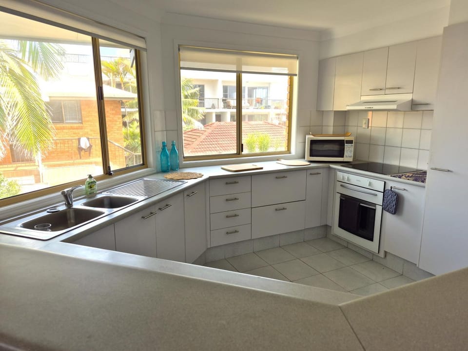 Kitchen or kitchenette, dishwasher, microwave, oven, stove
