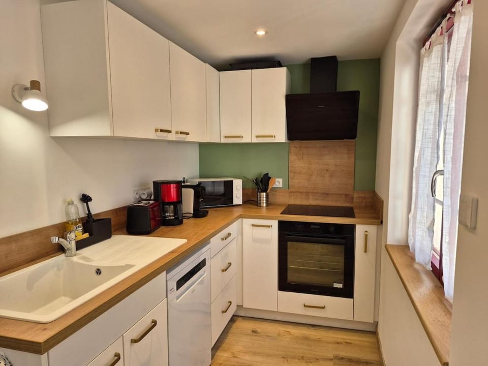 Kitchen or kitchenette, dishwasher, oven, stove, toaster