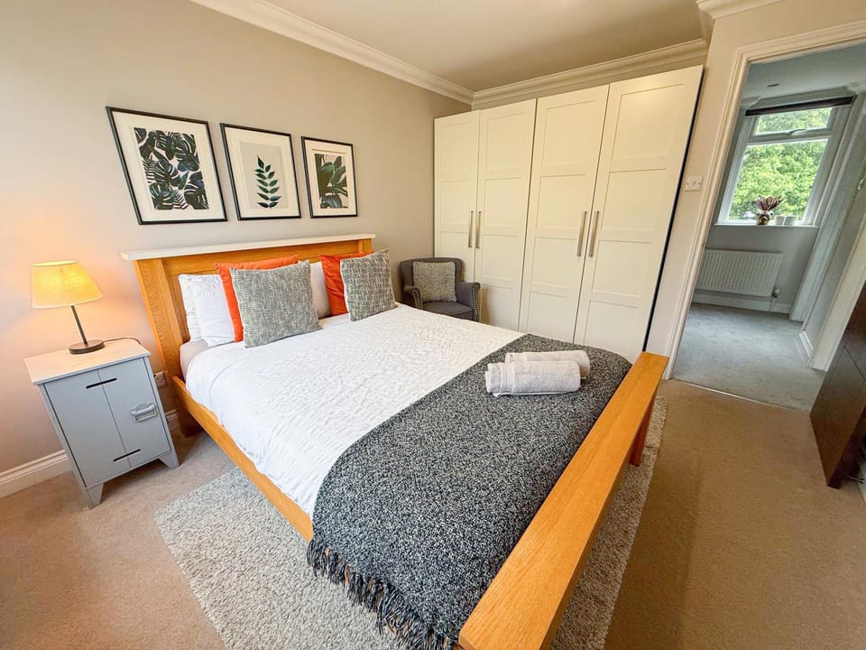 Bed, Decorative detail, Bedroom, flat iron, hair dryier, storage, towels, wardrobe