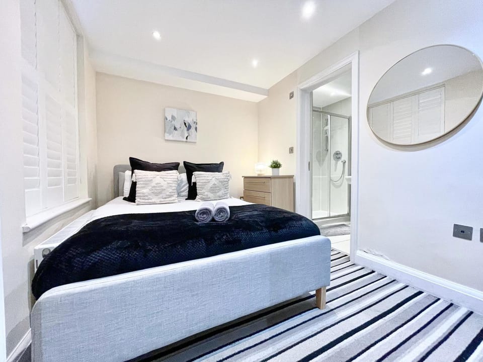 Bed, Bathroom, Photo of the whole room, Bedroom, flat iron, hair dryier, storage, towels, wardrobe