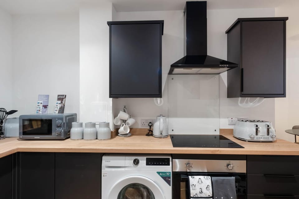 Kitchen or kitchenette, stove, toaster, washing machine