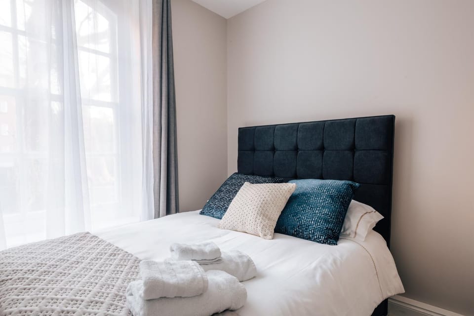Bed, Photo of the whole room, Bedroom, hair dryier, towels, wardrobe