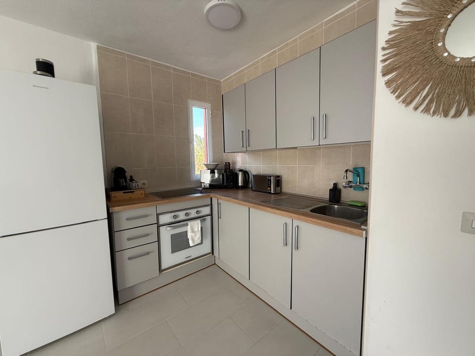 Kitchen or kitchenette, flat iron, microwave, oven, stove