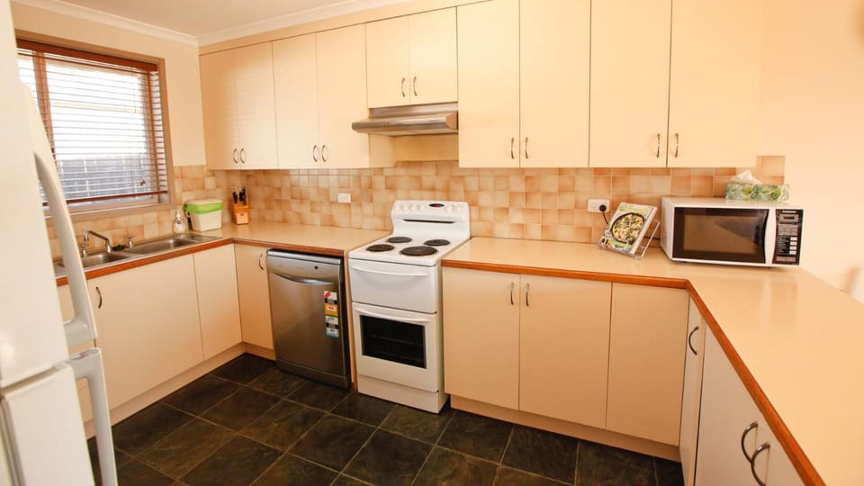 Kitchen or kitchenette, dishwasher, microwave, oven, stove