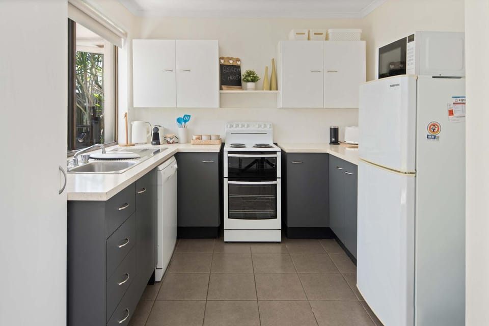 Kitchen or kitchenette, dishwasher, oven, stove