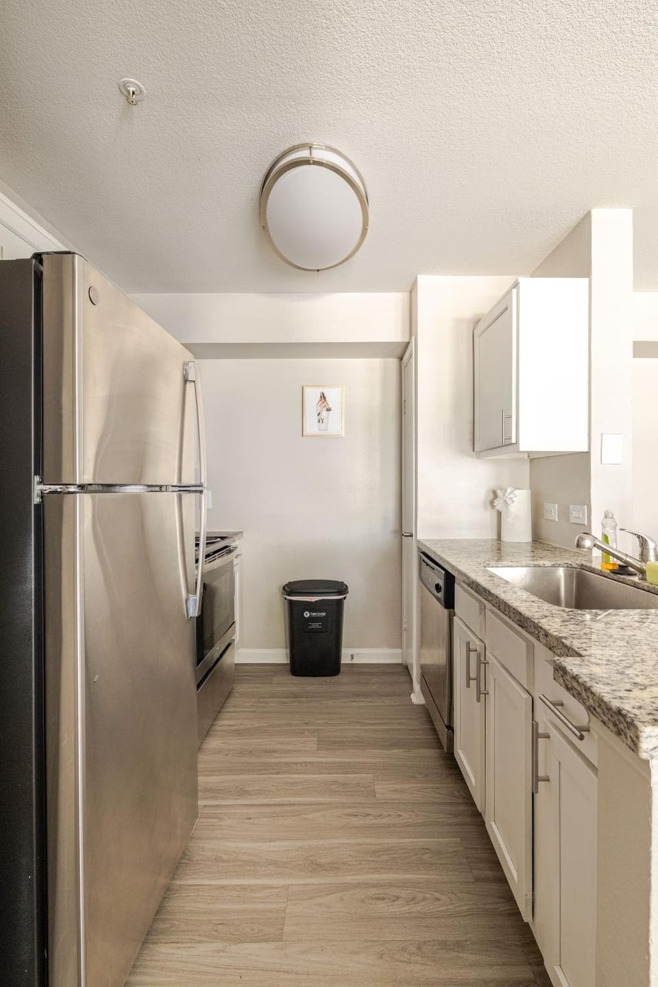 Kitchen or kitchenette, dishwasher, oven, stove