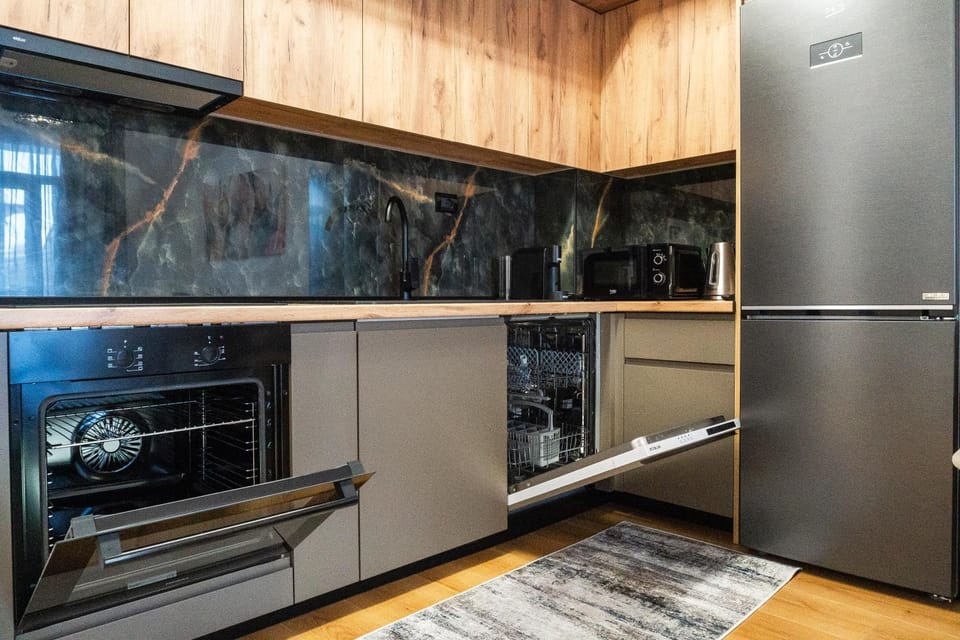 Kitchen or kitchenette, dishwasher, oven, stove