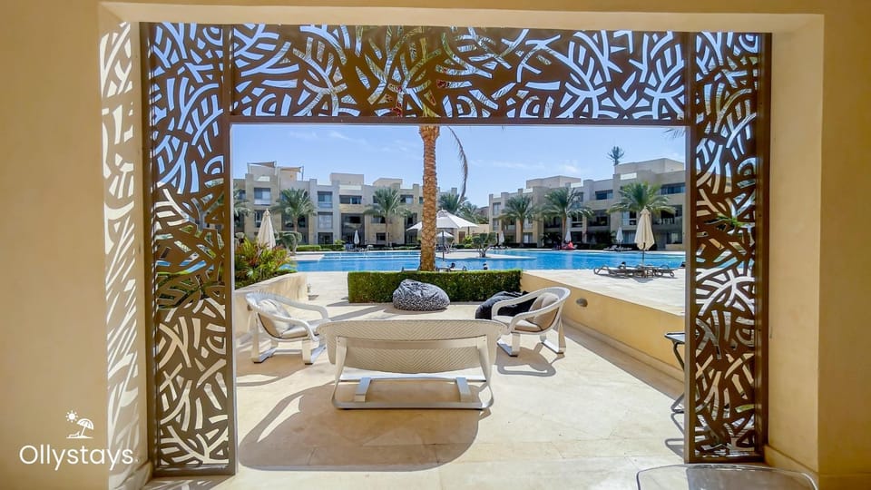 Property building, Patio, Property logo or sign, View (from property/room), Seating area, Swimming pool, sunbed