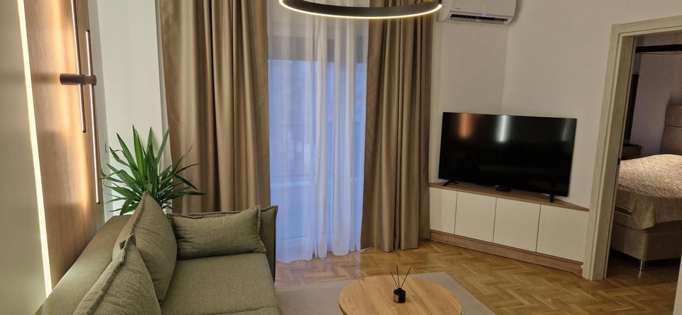 Bed, TV and multimedia, Living room, Seating area, air conditioner