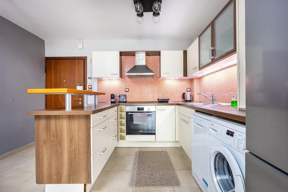 Kitchen or kitchenette, dishwasher, oven, stove, toaster, washing machine