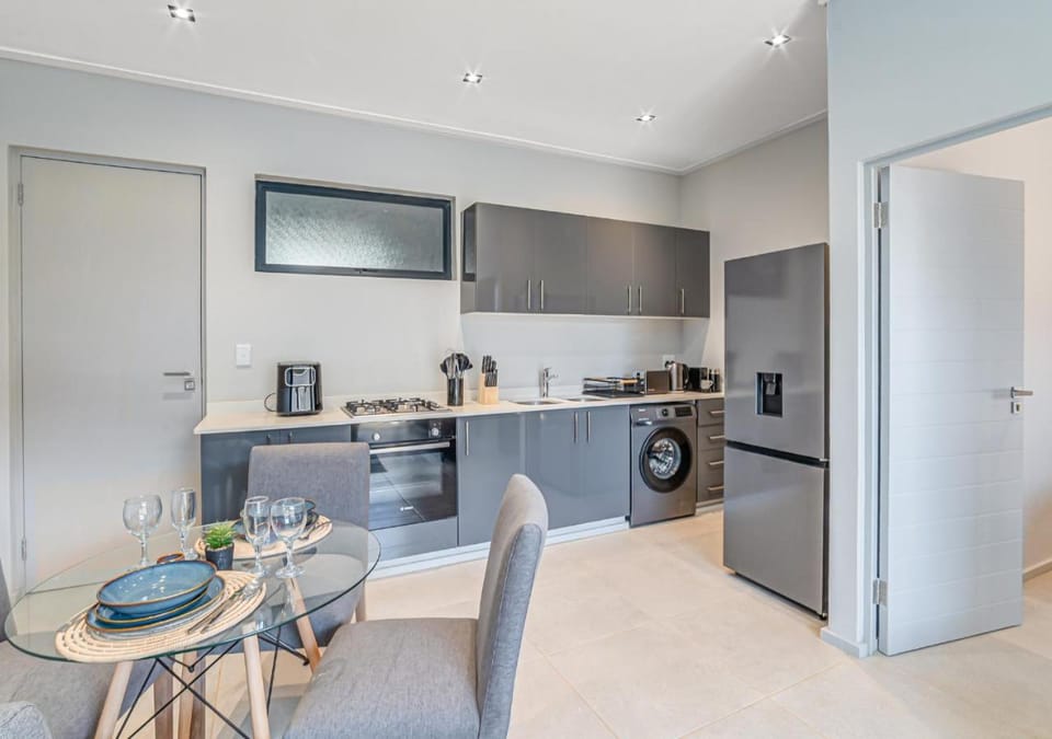 Photo of the whole room, Dining area, oven, stove, washing machine, kitchen