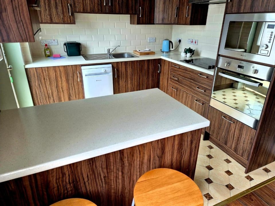 Kitchen or kitchenette, dishwasher, oven, stove
