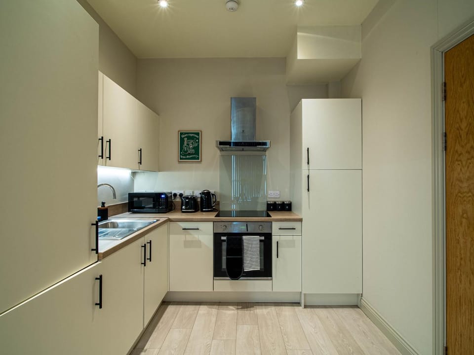Kitchen or kitchenette, dishwasher, oven, stove