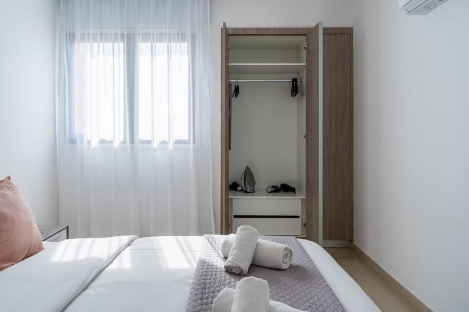 Bed, Bedroom, flat iron, hair dryier, towels, wardrobe