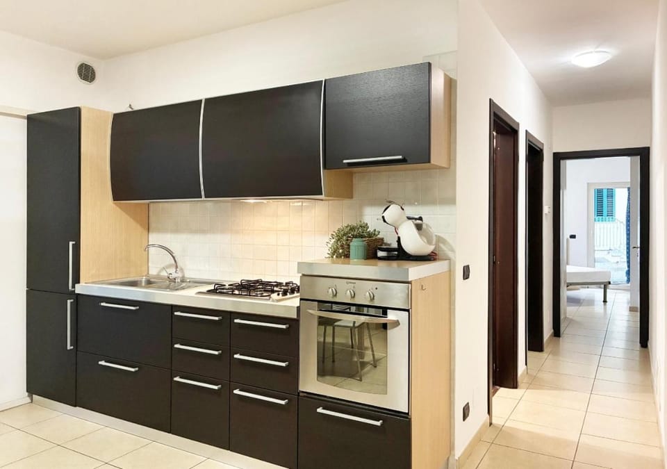 Kitchen or kitchenette, dishwasher, oven, stove
