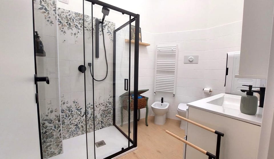 Shower, Toilet, Bathroom, bidet, bidet, hair dryier, towels, towels, washing machine, washing machine, washing machine, dryer