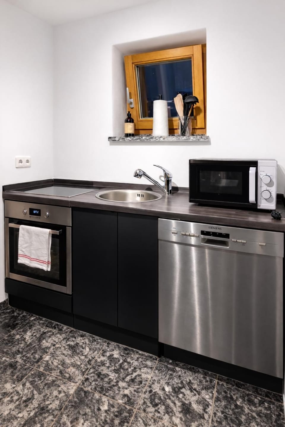 Kitchen or kitchenette, dishwasher, oven, stove