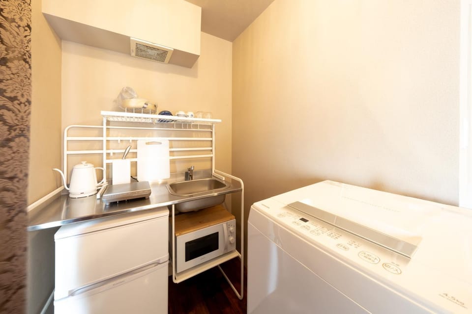 Kitchen or kitchenette, microwave, stove, washing machine, kitchen