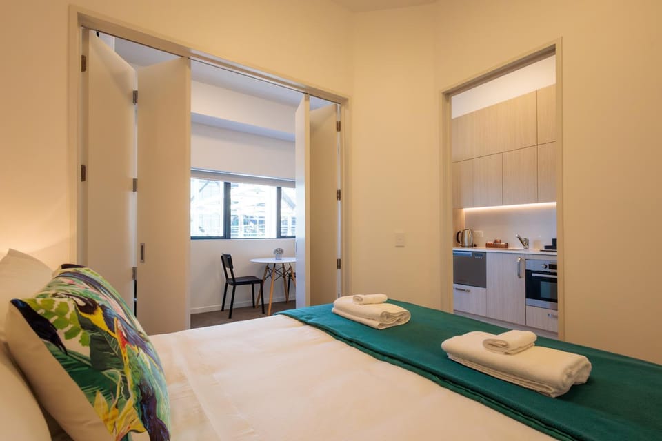Bed, Kitchen or kitchenette, Bedroom, dishwasher, oven, stove, toaster, towels