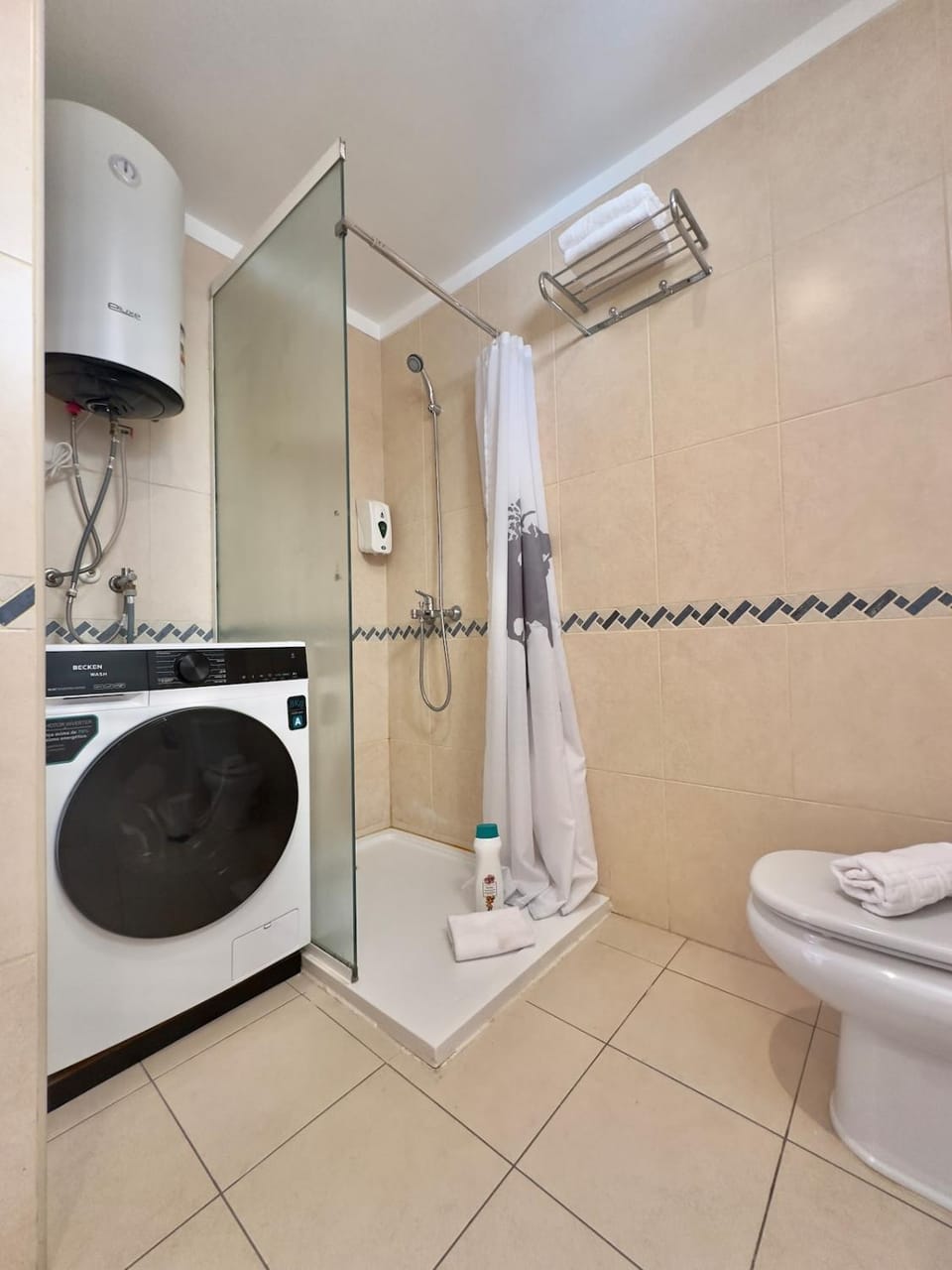 Shower, Toilet, Bathroom, bidet, hair dryier, towels, washing machine