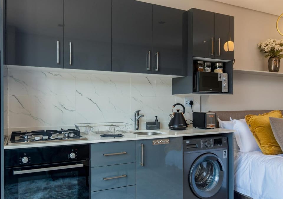 Kitchen or kitchenette, microwave, stove, washing machine