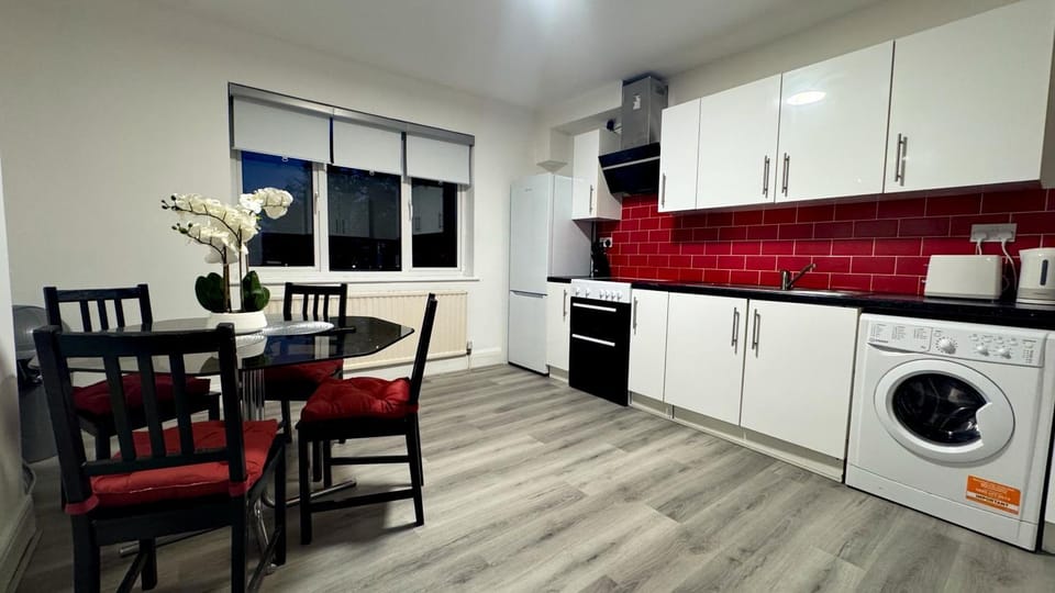Kitchen or kitchenette, Seating area, Dining area, oven, stove, toaster, washing machine