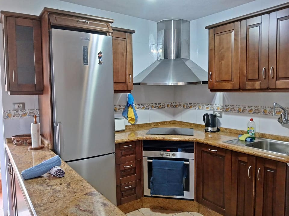 Kitchen or kitchenette, dishwasher, oven, stove
