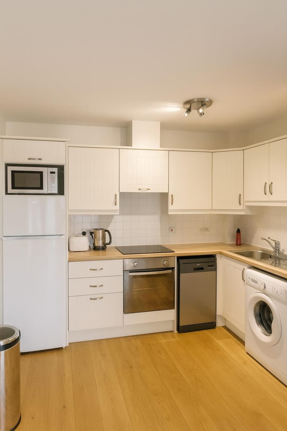 Kitchen or kitchenette, dishwasher, oven, toaster, dryer