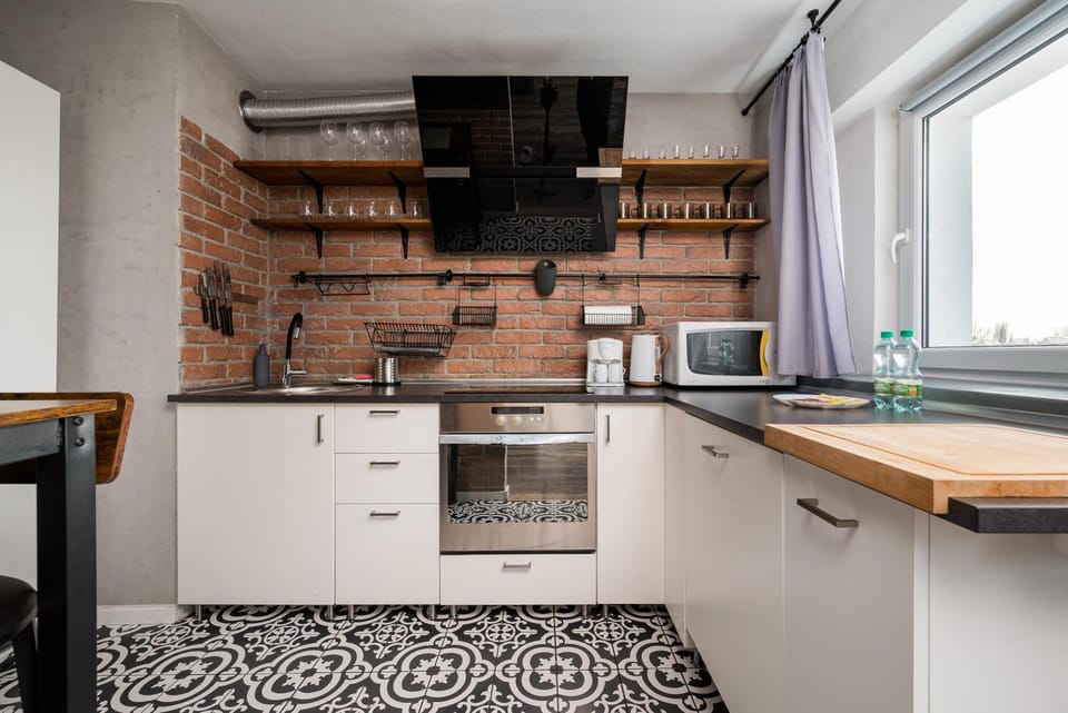 Kitchen or kitchenette, dishwasher, oven, stove
