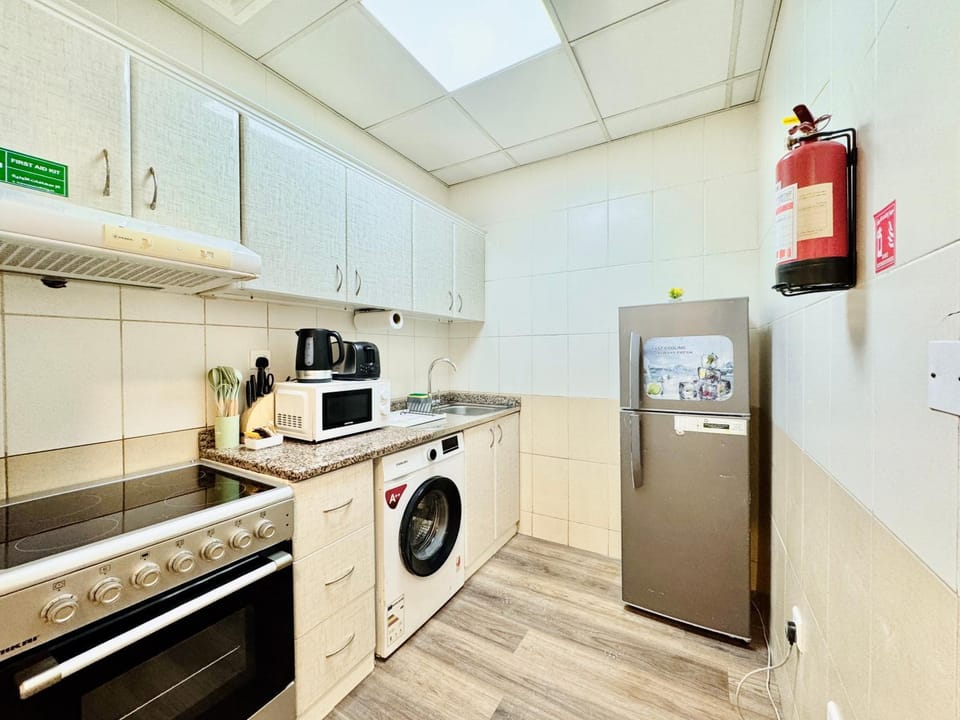 Kitchen or kitchenette, oven, stove, toaster, washing machine