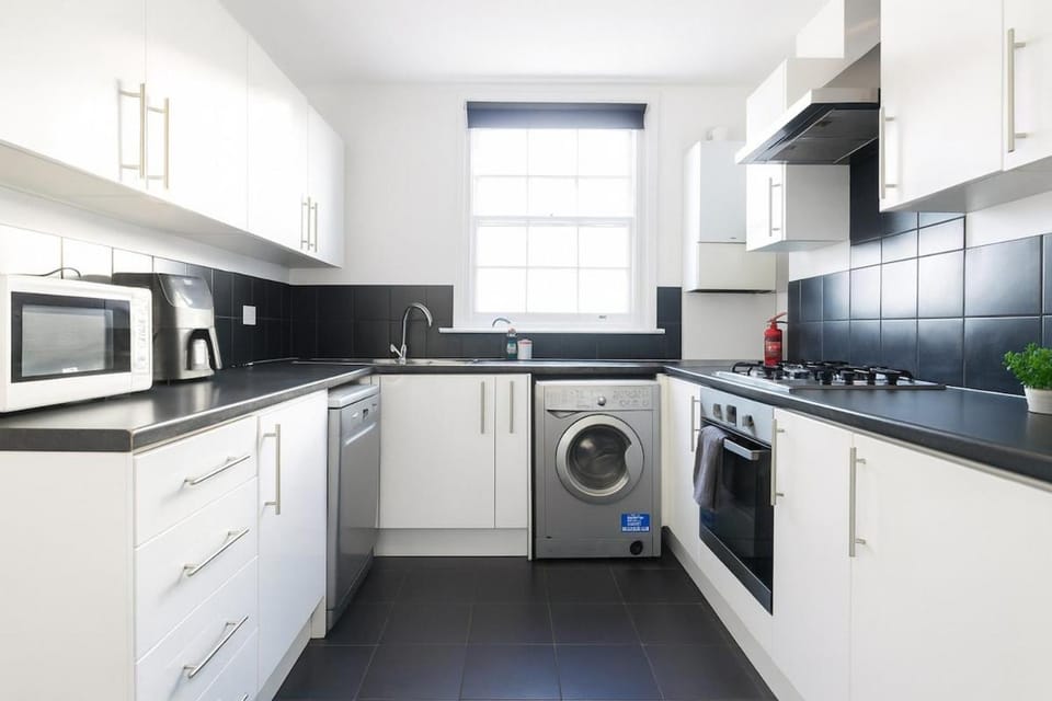 Kitchen or kitchenette, dishwasher, oven, stove, toaster, washing machine