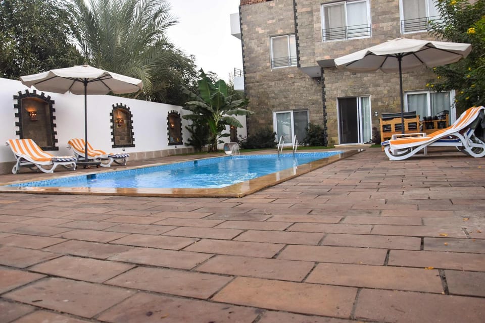 Property building, Patio, Day, Pool view, Swimming pool, sunbed