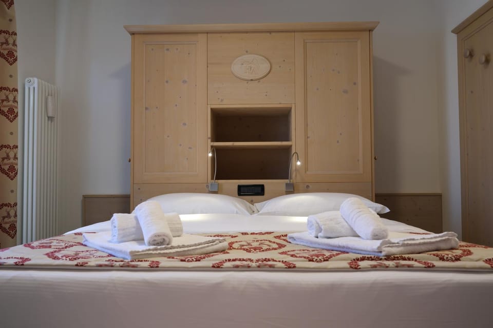 Bed, towels, wardrobe