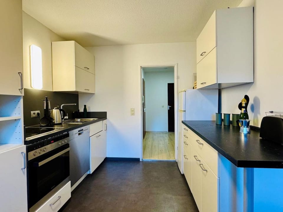 Kitchen or kitchenette, dishwasher, oven, stove