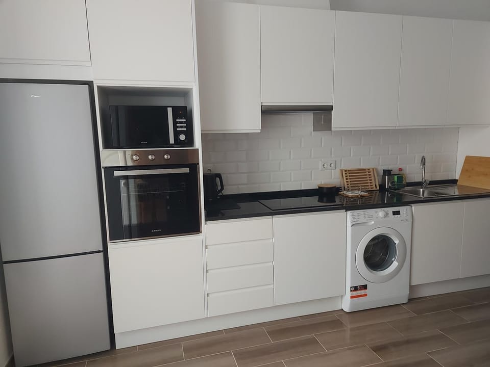 Kitchen or kitchenette, oven, stove, washing machine