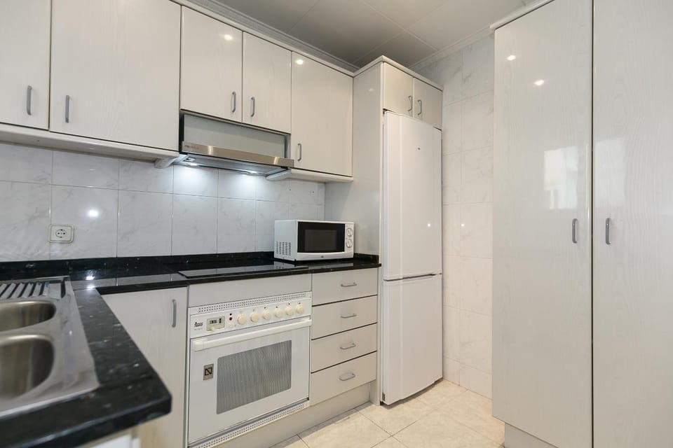 Kitchen or kitchenette, stove, washing machine
