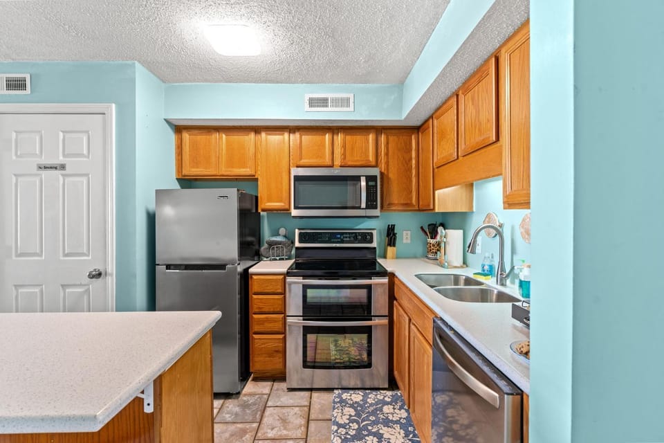 Kitchen or kitchenette, dishwasher, oven, stove