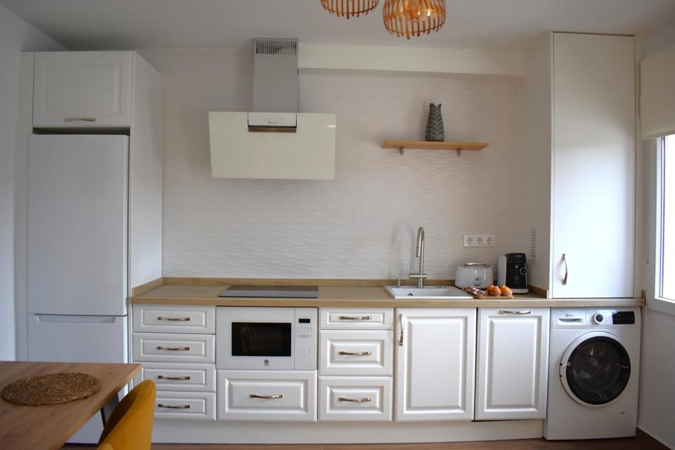Kitchen or kitchenette, dishwasher, microwave, stove, washing machine