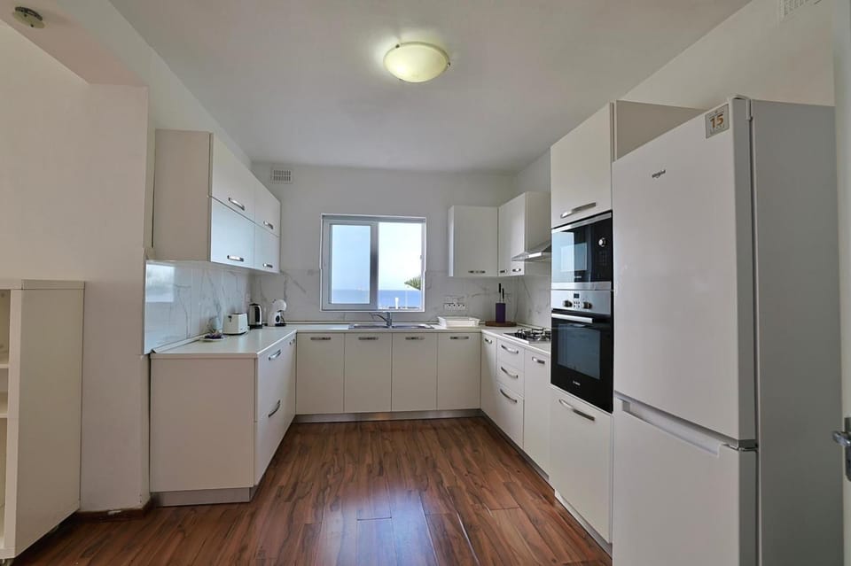 Kitchen or kitchenette, dishwasher, oven, stove