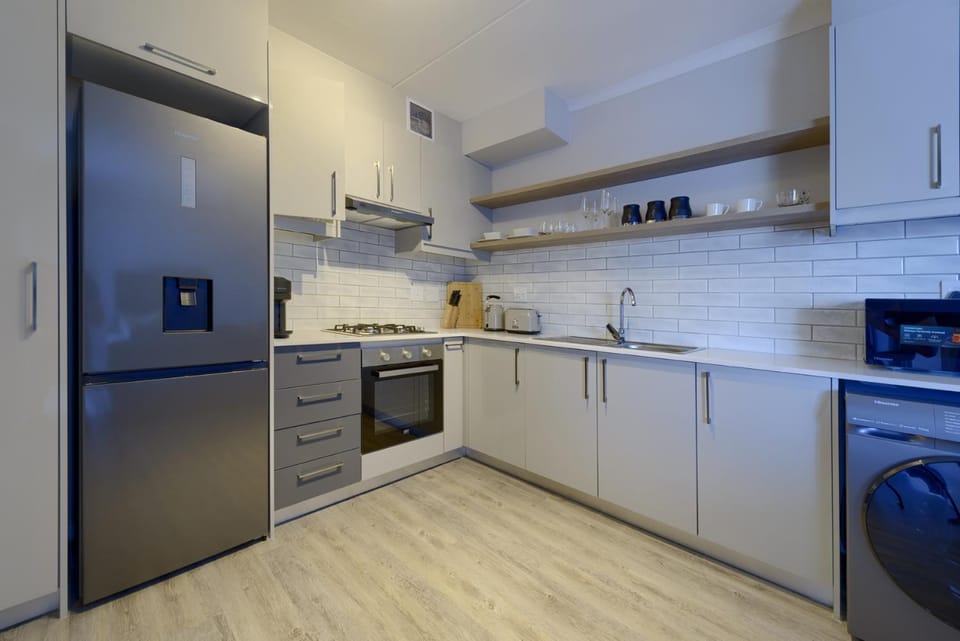 Kitchen or kitchenette, dishwasher, oven, stove, toaster, washing machine, kitchen