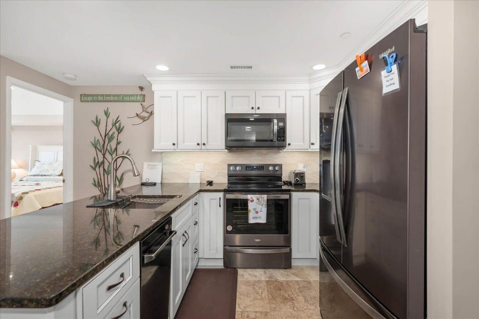 Kitchen or kitchenette, dishwasher, oven, stove, toaster