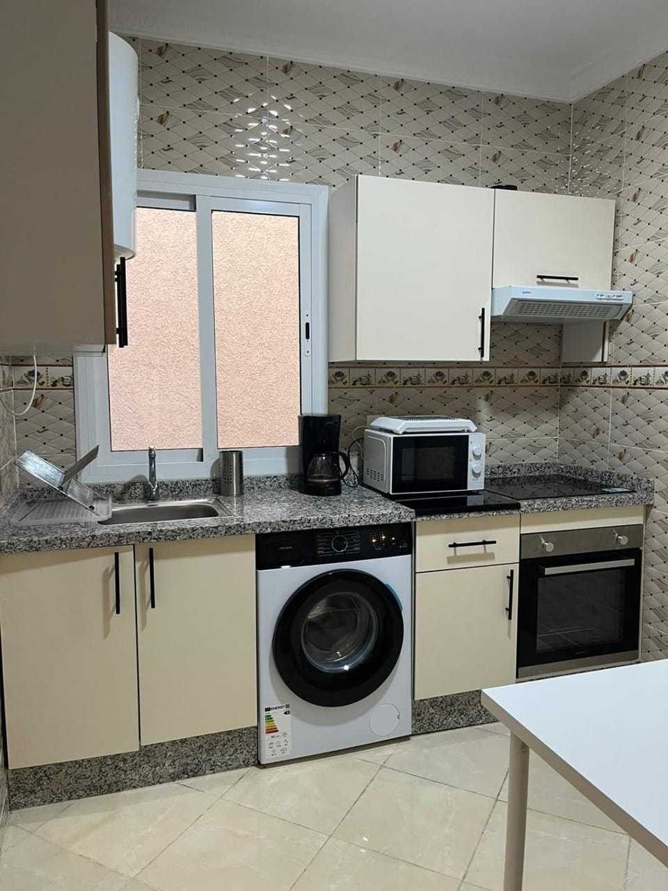 Kitchen or kitchenette, oven, stove, toaster, washing machine